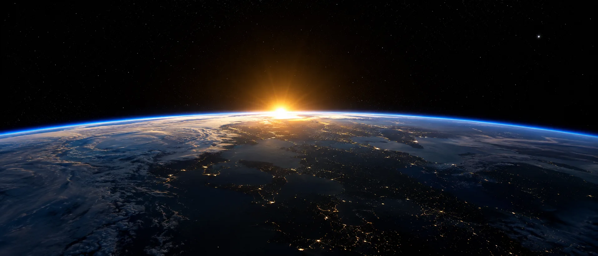 A borda da Terra vista do espaço, com o sol nascendo no horizonte